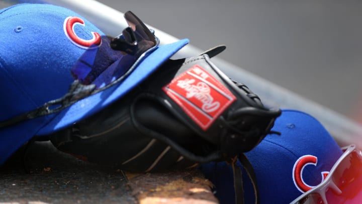 Mar 20, 2014; Mesa, AZ, USA; Chicago Cubs hats and mitts sit in the dugout against the Seattle Mariners at Cubs Park. The Mariners won 3-0.