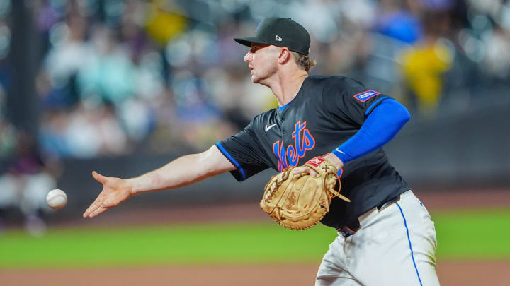 Jun 14, 2024; New York City, New York, USA; New York Mets first baseman Pete Alonso (20) flips the ball to pitcher Adam Ottavino (not pictured) covering first base after fielding a ground ball hit by San Diego Padres right fielder Frenando Tatis Jr. (not pictured)  during the sixth inning at Citi Field. Mandatory Credit: Gregory Fisher-USA TODAY Sports