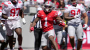 April 13, 2024; Columbus, Ohio, USA; 
Ohio State Buckeyes running back Quinshon Judkins (1) runs the football for the scarlet team while pursued by defensive end Kenyatta Jackson Jr. (97) and Jason Moore (94) of the grey team during the first half of the LifeSports spring football game at Ohio Stadium on Saturday.