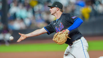 Jun 14, 2024; New York City, New York, USA; New York Mets first baseman Pete Alonso (20) flips the ball to pitcher Adam Ottavino (not pictured) covering first base after fielding a ground ball hit by San Diego Padres right fielder Frenando Tatis Jr. (not pictured)  during the sixth inning at Citi Field. 