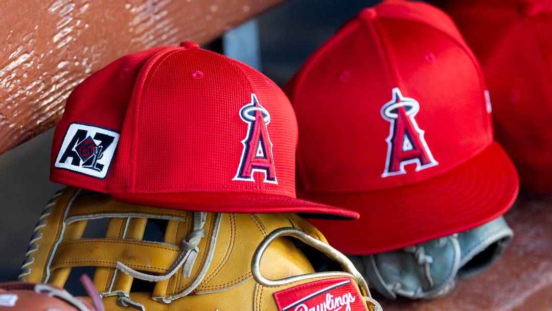 Feb 28, 2025; Phoenix, Arizona, USA; Detailed view of the Los Angeles Angels logo on a hat in the dugout during a spring training game at Camelback Ranch-Glendale. Mandatory Credit: Mark J. Rebilas-Imagn Images