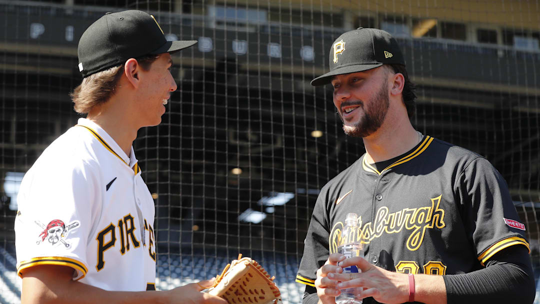Jul 22, 2025; Pittsburgh, Pennsylvania, USA;  Seth Hernandez (left) the Pittsburgh Pirates first round and number six overall pick in the 2025 first year player draft talks with Pirates pitcher Paul Skenes (30) before the game against the Detroit Tigers at PNC Park. Mandatory Credit: Charles LeClaire-Imagn Images