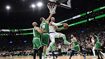 Feb 23, 2025; Boston, Massachusetts, USA;  New York Knicks guard Josh Hart (3) looks to pass the ball past Boston Celtics center Kristaps Porzingis (8) and h9#@ during the first half at TD Garden. Mandatory Credit: Bob DeChiara-Imagn Images