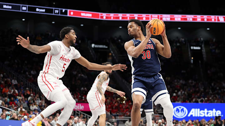 Mar 15, 2025; Kansas City, MO, USA; Arizona Wildcats forward Tobe Awaka (30) attempts to shoot the ball against Houston Cougars forward Ja'Vier Francis (5) during the second half for the Big 12 Conference Tournament Championship game at T-Mobile Center. Mandatory Credit: William Purnell-Imagn Images