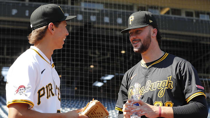Jul 22, 2025; Pittsburgh, Pennsylvania, USA;  Seth Hernandez (left) the Pittsburgh Pirates first round and number six overall pick in the 2025 first year player draft talks with Pirates pitcher Paul Skenes (30) before the game against the Detroit Tigers at PNC Park. Mandatory Credit: Charles LeClaire-Imagn Images