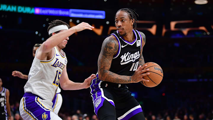 Dec 28, 2024; Los Angeles, California, USA; Sacramento Kings forward DeMar DeRozan (10) moves the ball against Los Angeles Lakers guard Austin Reaves (15) during the first half at Crypto.com Arena. Mandatory Credit: Gary A. Vasquez-Imagn Images
