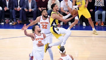 Indiana Pacers guard Tyrese Haliburton (0) shoots against New York Knicks guard Jalen Brunson (11) and center Karl-Anthony Towns (32) in the first quarter during game one of the Eastern Conference Finals.