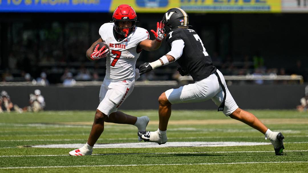 Sep 19, 2026; Nashville, Tennessee, USA; NC State Wolfpack running back Davion Gause (7) stiff arms Vanderbilt Commodores safety Ricardo Jones (7) during the second half at FirstBank Stadium. Mandatory Credit: Steve Roberts-Imagn Images Sep 19, 2026; Nashville, Tennessee, USA; NC State Wolfpack running back Davion Gause (7) stiff arms Vanderbilt Commodores safety Ricardo Jones (7) during the second half at FirstBank Stadium. Mandatory Credit: Steve Roberts-Imagn Images