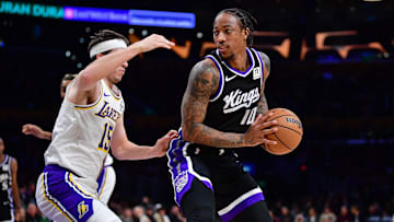 Dec 28, 2024; Los Angeles, California, USA; Sacramento Kings forward DeMar DeRozan (10) moves the ball against Los Angeles Lakers guard Austin Reaves (15) during the first half at Crypto.com Arena. Mandatory Credit: Gary A. Vasquez-Imagn Images