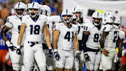 Sep 7, 2024; Gainesville, Florida, USA; Samford Bulldogs wide receiver Stephen Martin (18), tight end Tate Taylor (41), tight end Daniel Bettis (93) and teammates look toward the sideline against the Florida Gators during the first half at Ben Hill Griffin Stadium. Mandatory Credit: Matt Pendleton-Imagn Images
