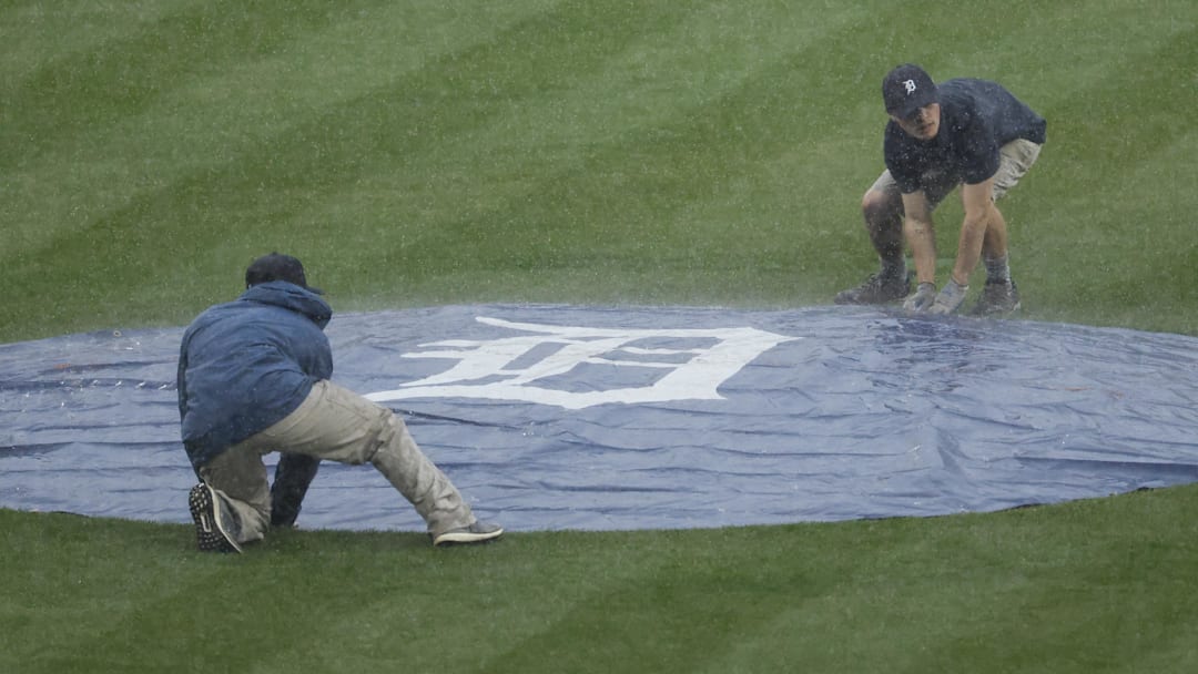 Grounds crew cover the field during the ninth inning of the game between the Detroit Tigers and the St. Louis Cardinals at Comerica Park. Grounds crew cover the field during the ninth inning of the game between the Detroit Tigers and the St. Louis Cardinals at Comerica Park.