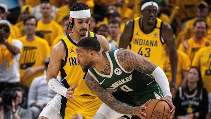 Milwaukee Bucks guard Damian Lillard (0) holds the ball while Indiana Pacers guard Andrew Nembhard (2) defends during game six of the first round for the 2024 NBA playoffs at Gainbridge Fieldhouse.