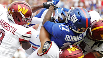Sep 7, 2025; Landover, Maryland, USA; New York Giants wide receiver Wan'Dale Robinson (17) is tackled during the first quarter against the Washington Commanders at Northwest Stadium. Mandatory Credit: Amber Searls-Imagn Images
