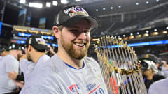 Jordan Montgomery holds the Commissioner's Trophy in celebration of the Rangers winning the 2023 World Series.
