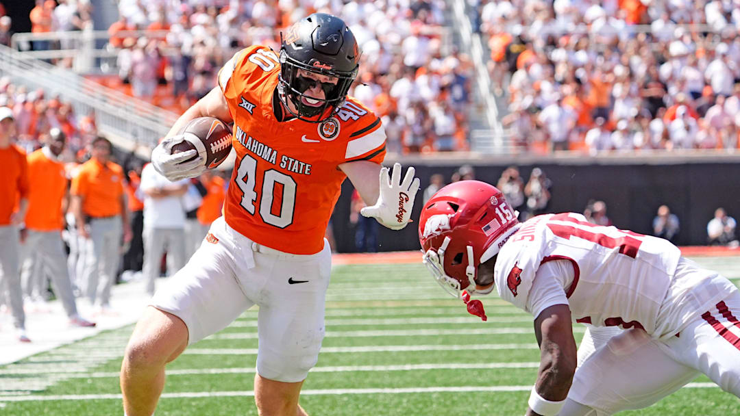 Oklahoma State's Josh Ford (40) looks to get past Arkansas' Jaheim Singletary (15) in the second half of the college football game between the Oklahoma State Cowboys and the Arkansas Razorbacks at Boone Pickens Stadium in Stillwater, Okla.,, Saturday, Sept., 7, 2024.