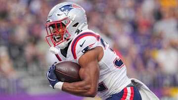 Aug 16, 2025; Minneapolis, Minnesota, USA; New England Patriots running back TreVeyon Henderson (32) celebrates his touchdown against the Minnesota Vikings in the first quarter at U.S. Bank Stadium. Mandatory Credit: Brad Rempel-Imagn Images