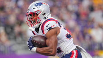 New England Patriots running back TreVeyon Henderson (32) celebrates his touchdown against the Minnesota Vikings in the first quarter at U.S. Bank Stadium.