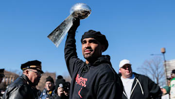 Philadelphia Eagles quarterback Jalen Hurts (1) raises the Lombardi Trophy during the Super Bowl LIX championship parade and rally.