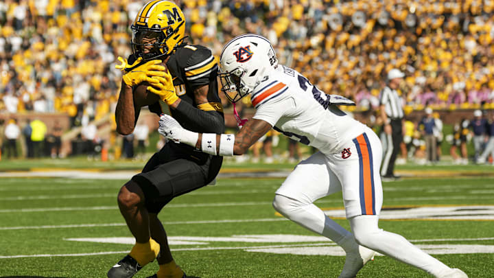 Oct 19, 2024; Columbia, Missouri, USA; Missouri Tigers wide receiver Theo Wease Jr. (1) runs with the ball against Auburn Tigers cornerback Jay Crawford (23) during the second half at Faurot Field at Memorial Stadium. Mandatory Credit: Jay Biggerstaff-Imagn Images Oct 19, 2024; Columbia, Missouri, USA; Missouri Tigers wide receiver Theo Wease Jr. (1) runs with the ball against Auburn Tigers cornerback Jay Crawford (23) during the second half at Faurot Field at Memorial Stadium. Mandatory Credit: Jay Biggerstaff-Imagn Images