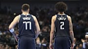 Dec 3, 2024; Dallas, Texas, USA;  Dallas Mavericks guard Luka Doncic (77) and Dallas Mavericks center Dereck Lively II (2) look on during the second half against the Memphis Grizzlies at American Airlines Center. Mandatory Credit: Kevin Jairaj-Imagn Images