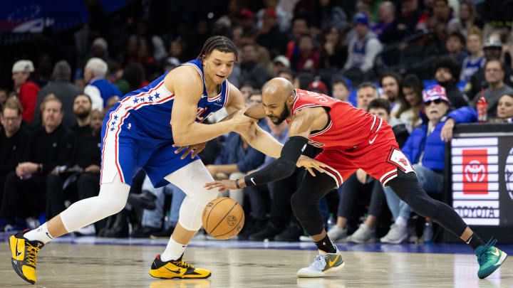 Jan 2, 2024; Philadelphia, Pennsylvania, USA; Philadelphia 76ers Kenneth Lofton Jr. looses the ball to Chicago Bulls guard Jevon Carter (5) during the fourth quarter at Wells Fargo Center. Mandatory Credit: Bill Streicher-USA TODAY Sports