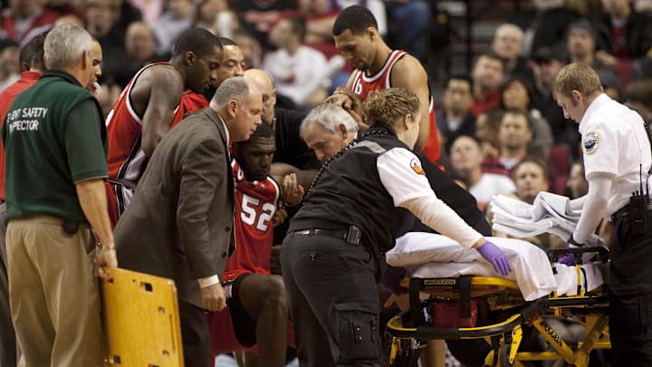 Dec 5, 2009; Portland, OR, USA;  Portland Trailblazers center Greg Oden (52) is loaded onto a stretcher after a collision with Houston Rockets guard Aaron Brooks (not pictured) in the first quarter at the Rose Garden. Mandatory Credit: Craig Mitchelldyer-Imagn Images