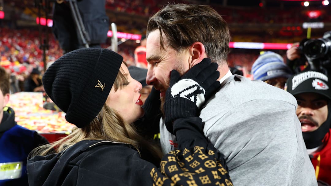 Jan 26, 2025; Kansas City, MO, USA; Recording artist Taylor Swift  and Kansas City Chiefs tight end Travis Kelce (87) react after the AFC Championship game against the Buffalo Bills at GEHA Field at Arrowhead Stadium. 