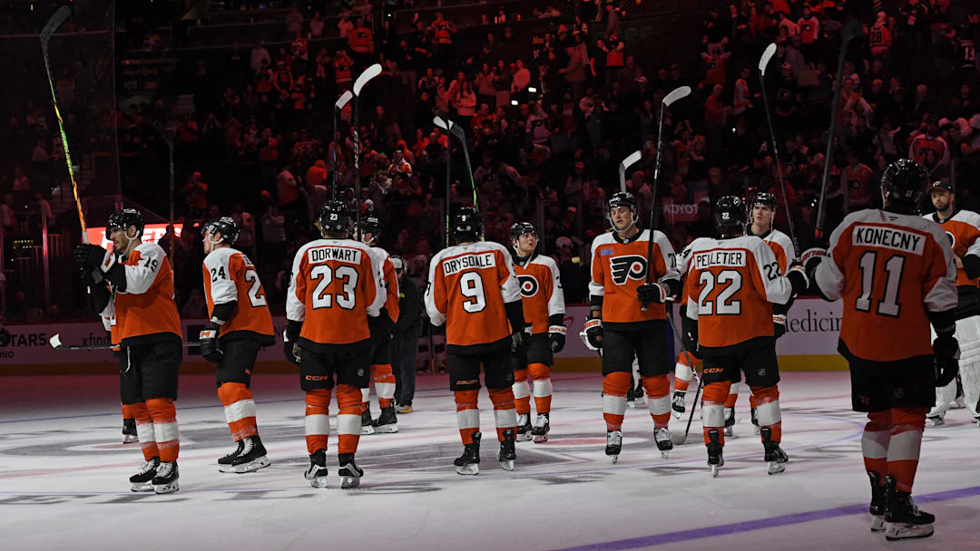Apr 15, 2025; Philadelphia, Pennsylvania, USA; Philadelphia Flyers players salute the fans after loss to the Columbus Blue Jackets at Wells Fargo Center.