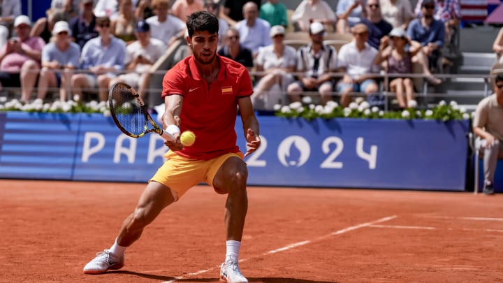 Aug 1, 2024; Paris, France; Carlos Alcaraz of Team Spain hits the ball during the Paris 2024 Olympic Summer Games at Stade Roland Garros. Mandatory Credit: Andrew P. Scott-USA TODAY Sports