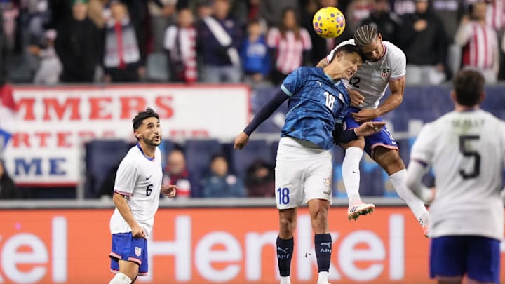 Nov 15, 2025; Chester, Pennsylvania, USA; Paraguay forward Alex Arce (18) and United States defender Miles Robinson (12) jump for a header in the first half at Subaru Park. Mandatory Credit: Kyle Ross-Imagn Images