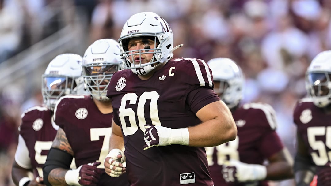 Texas A&M Aggies offensive lineman Trey Zuhn III (60) and the offense runs onto the field in the first half against the Florida Gators at Kyle Field. 