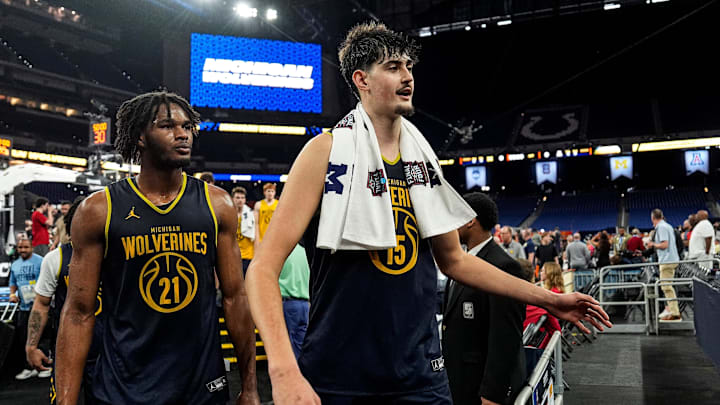Michigan center Aday Mara (15), center, and forward Morez Johnson Jr. (21), left, walk off the court after open practice at Lucas Oil Stadium in Indianapolis on Friday, April 3, 2026.