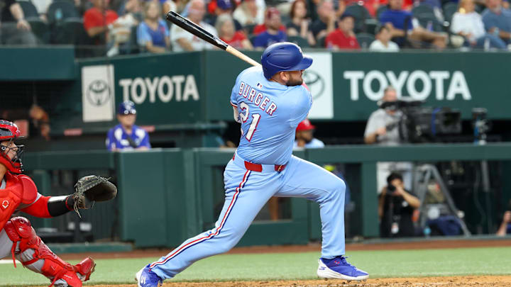 Jun 1, 2025; Arlington, Texas, USA; Texas Rangers designated hitter Jake Burger (21) hits an rbi double during the eighth inning against the St. Louis Cardinals at Globe Life Field. 