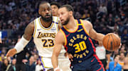 Jan 25, 2025; San Francisco, California, USA; Golden State Warriors guard Stephen Curry (30) dribbles against Los Angeles Lakers forward LeBron James (23) during the third quarter at Chase Center. Mandatory Credit: Darren Yamashita-Imagn Images