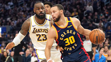 Jan 25, 2025; San Francisco, California, USA; Golden State Warriors guard Stephen Curry (30) dribbles against Los Angeles Lakers forward LeBron James (23) during the third quarter at Chase Center. Mandatory Credit: Darren Yamashita-Imagn Images