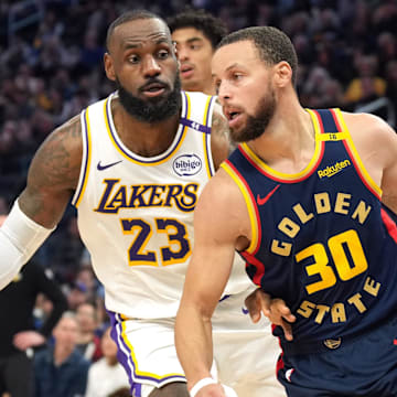 Jan 25, 2025; San Francisco, California, USA; Golden State Warriors guard Stephen Curry (30) dribbles against Los Angeles Lakers forward LeBron James (23) during the third quarter at Chase Center. Mandatory Credit: Darren Yamashita-Imagn Images