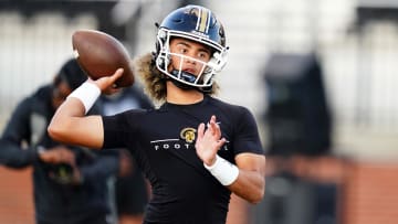 Carrollton QB Julian Lewis (10) warms up to play Westlake at Grisham Stadium. 