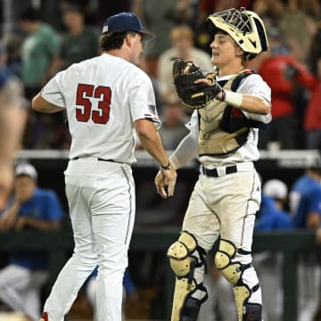 Jun 15, 2024; Omaha, NE, USA;  Texas A&M Aggies pitcher Evan Aschenbeck (53) and catcher Jackson Appel (20) celebrate the win against the Florida Gators at Charles Schwab Field Omaha. Mandatory Credit: Steven Branscombe-USA TODAY Sports