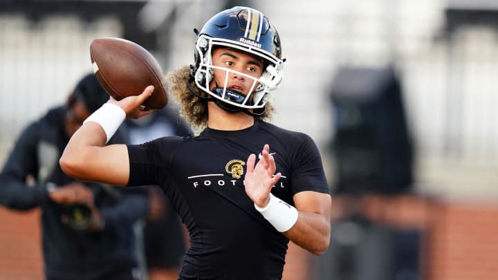 Carrollton QB Julian Lewis (10) warms up to play Westlake at Grisham Stadium. 