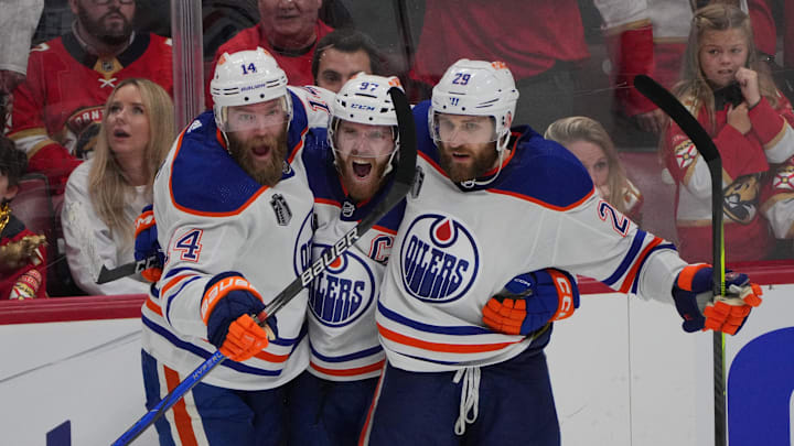 Jun 18, 2024; Sunrise, Florida, USA; Edmonton Oilers forward Connor McDavid (97) celebrates scoring an empty net goal with defenseman Mattias Ekholm (14) and forward Adam Henrique (19) during the third period against the Florida Panthers in game five of the 2024 Stanley Cup Final at Amerant Bank Arena. Mandatory Credit: Jim Rassol-Imagn Images