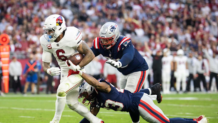Dec 15, 2024; Glendale, Arizona, USA; Arizona Cardinals running back James Conner (6) is tackled by New England Patriots defensive tackle Daniel Ekuale (95) at State Farm Stadium. Mandatory Credit: Mark J. Rebilas-Imagn Images