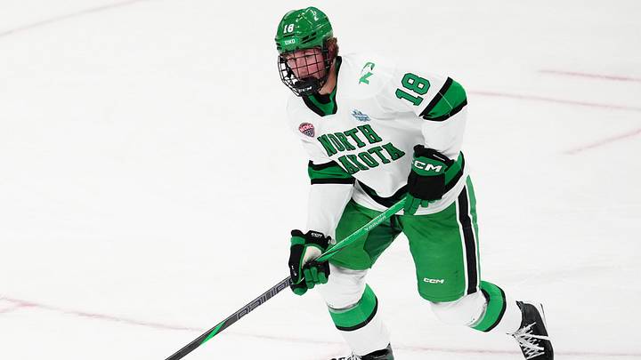 Apr 9, 2026; Las Vegas, Nevada, UNITED STATES;  North Dakota Fighting Hawks defenseman Keaton Verhoeff (18) moves the puck in the first period against the Wisconsin Badgers  in the semifinals of the NCAA men's ice hockey Frozen Four at T-Mobile Arena. 