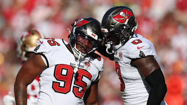 Tampa Bay Buccaneers linebacker Yaya Diaby (0) and defensive end Elijah Roberts (95) react after a sack 