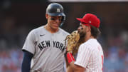 Jul 30, 2024; Philadelphia, Pennsylvania, USA; New York Yankees outfielder Aaron Judge (99) with Philadelphia Phillies first base Bryce Harper (3) on first base after his single during the first inning at Citizens Bank Park.