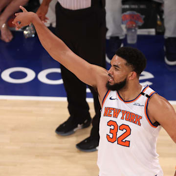 New York Knicks center Karl-Anthony Towns reacts after a three point shot against the Indiana Pacers. Mandatory Credit: Vincent Carchietta-Imagn Images