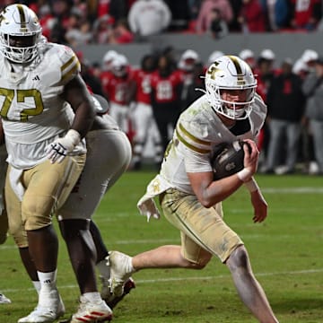 Nov 1, 2025; Raleigh, North Carolina, USA;  Georgia Tech Yellow Jackets quarterback Haynes King (10) scores a touchdown during the fourth quarter against the NC State Wolfpack at Carter-Finley Stadium. Mandatory Credit: Zachary Taft-Imagn Images