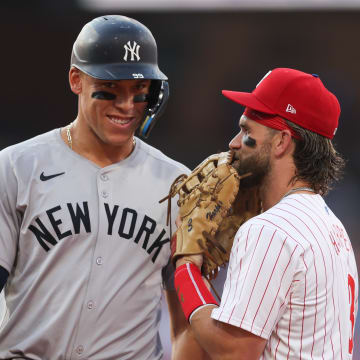 Jul 30, 2024; Philadelphia, Pennsylvania, USA; New York Yankees outfielder Aaron Judge (99) with Philadelphia Phillies first base Bryce Harper (3) on first base after his single during the first inning at Citizens Bank Park.