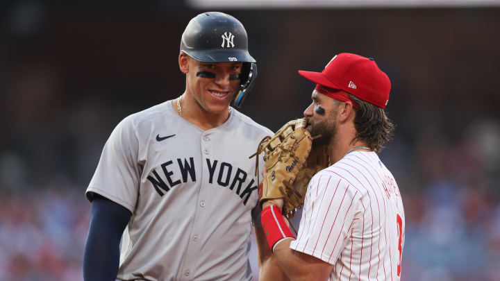 Jul 30, 2024; Philadelphia, Pennsylvania, USA; New York Yankees outfielder Aaron Judge (99) with Philadelphia Phillies first base Bryce Harper (3) on first base after his single during the first inning at Citizens Bank Park.