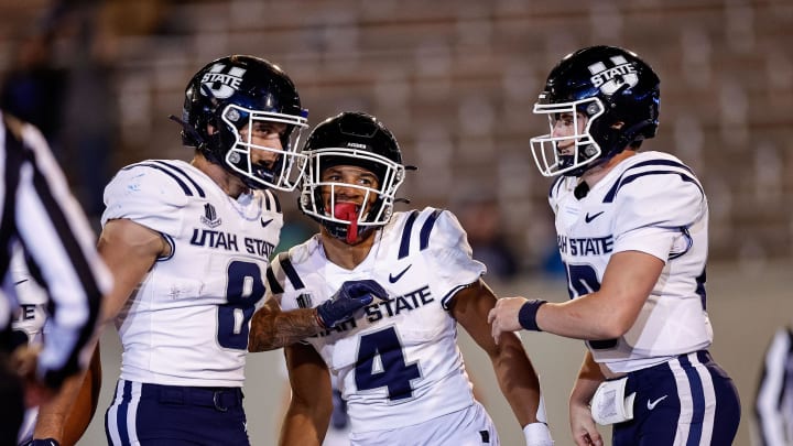 Sep 15, 2023; Colorado Springs, Colorado, USA; Utah State Aggies wide receiver Micah Davis (4) celebrates his touchdown with wide receiver Colby Bowman (8) and quarterback McCae Hillstead (10) in the fourth quarter against the Air Force Falcons at Falcon Stadium. Mandatory Credit: Isaiah J. Downing-USA TODAY Sports