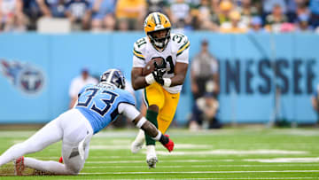 Sep 22, 2024; Nashville, Tennessee, USA;  Tennessee Titans safety Jamal Adams (33) tackles Green Bay Packers running back Emanuel Wilson (31) during the first half at Nissan Stadium. Mandatory Credit: Steve Roberts-Imagn Images